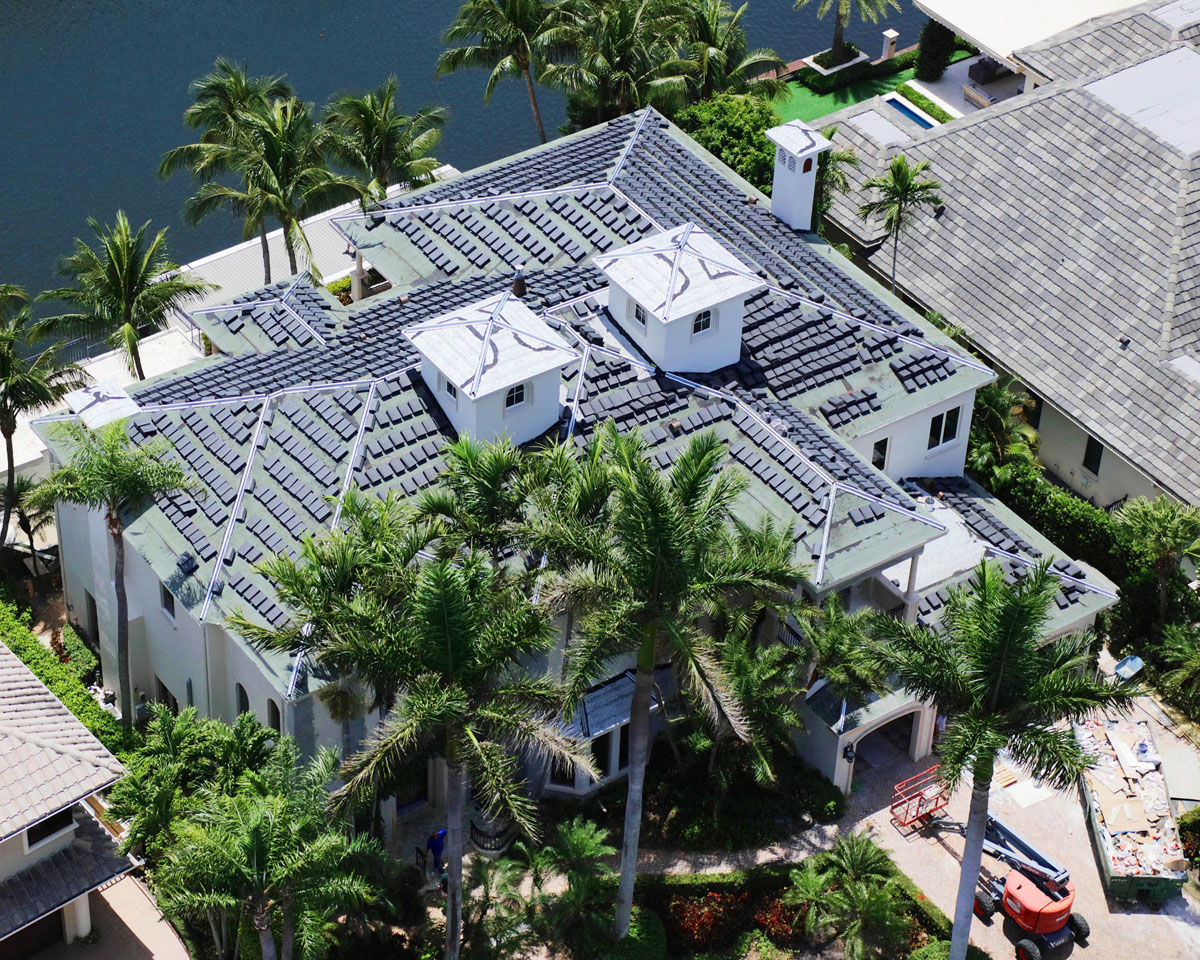 large home near body of water with palm trees