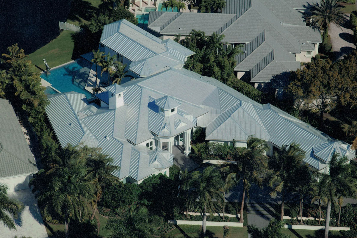 large wide home with palm trees