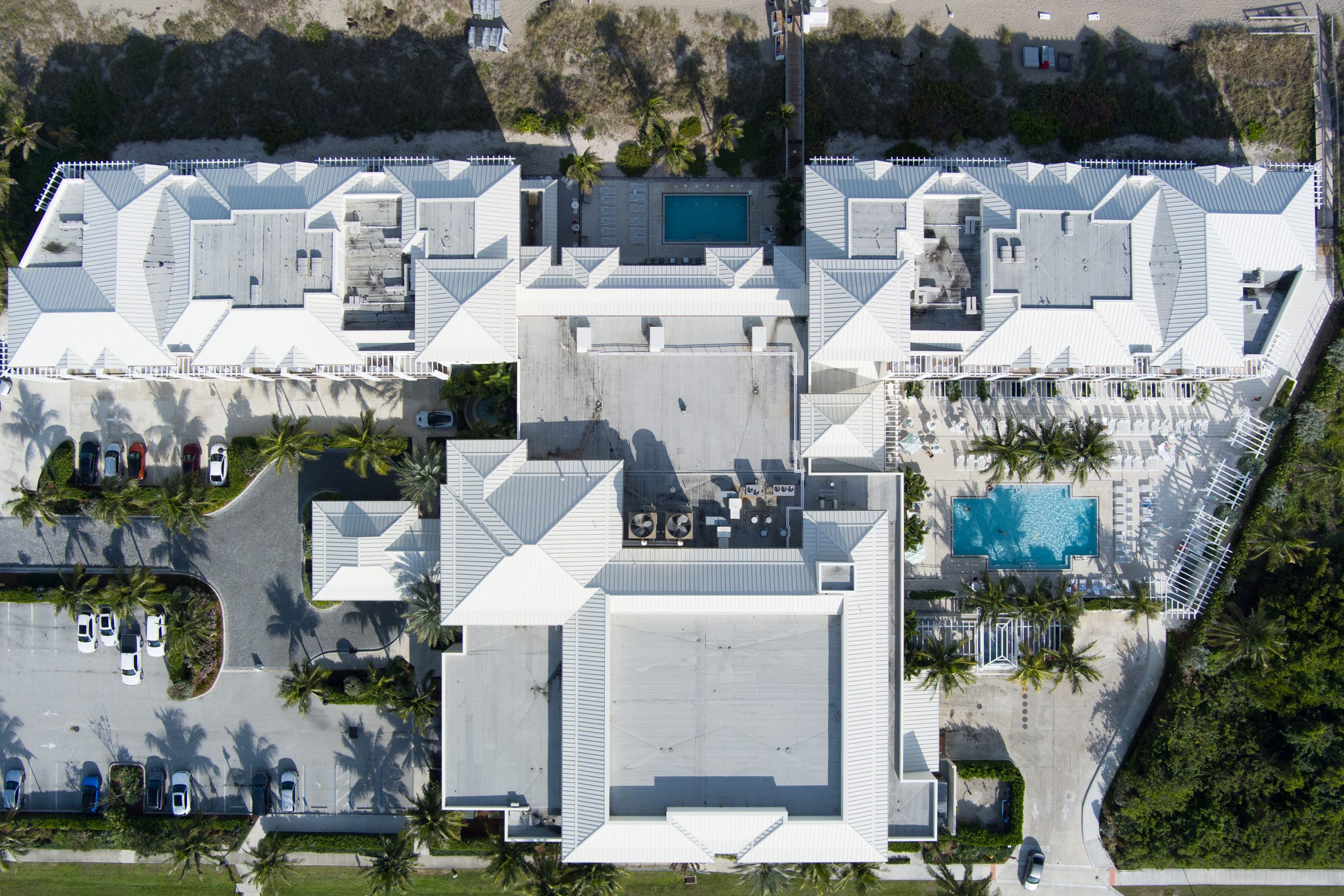 aerial view of large wide complex with pool